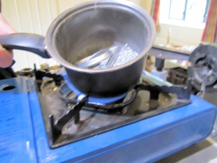 Melting down the pewter on a camping stove